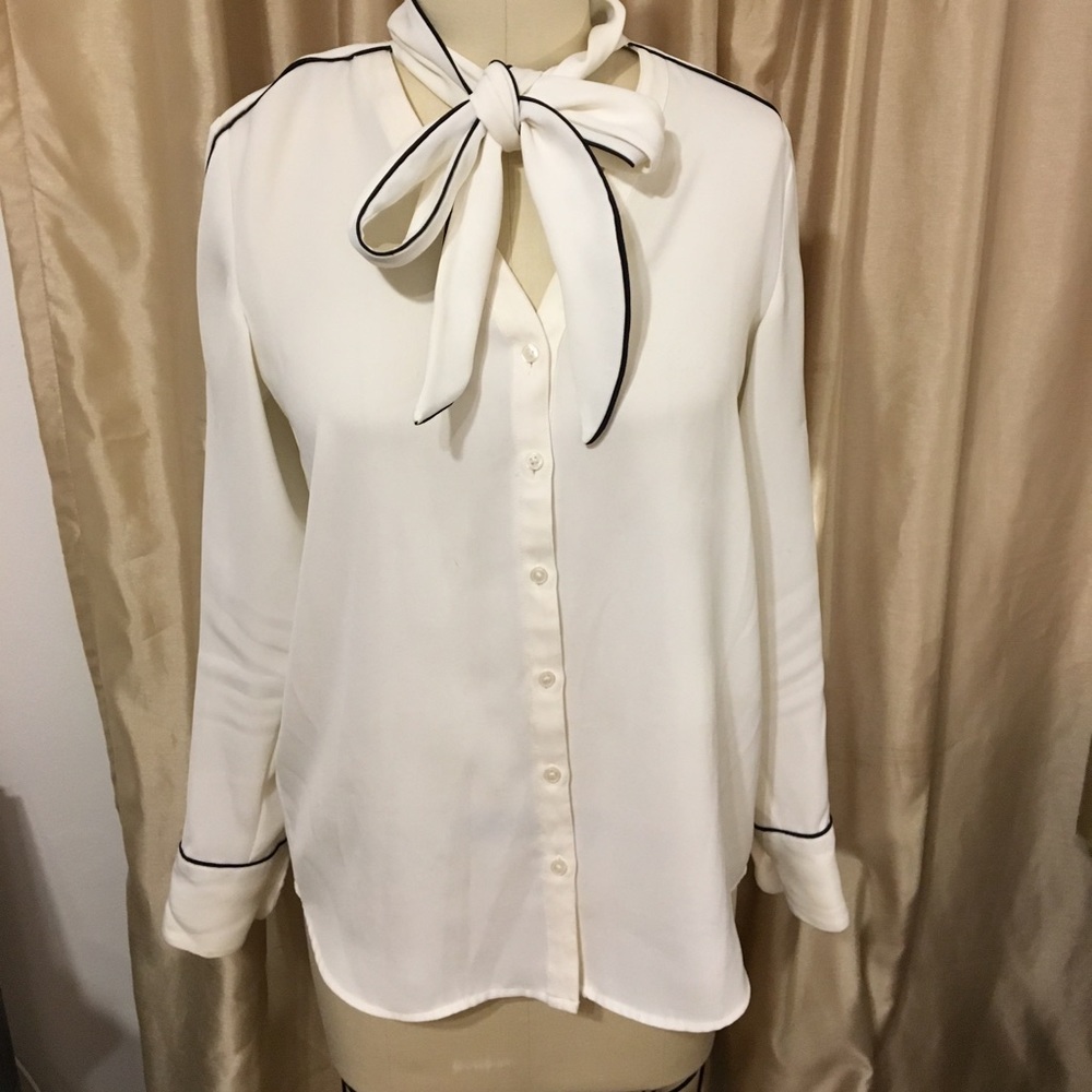 Tie neck blouse with black piping detail.